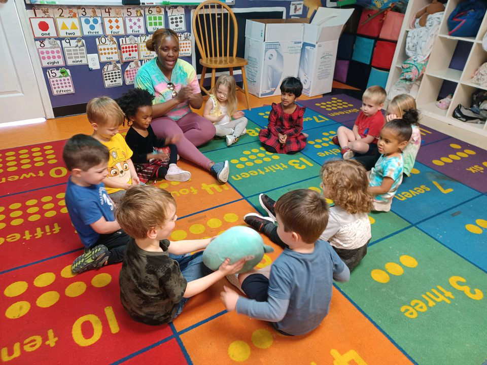 Children playing in a colorful classroom circle