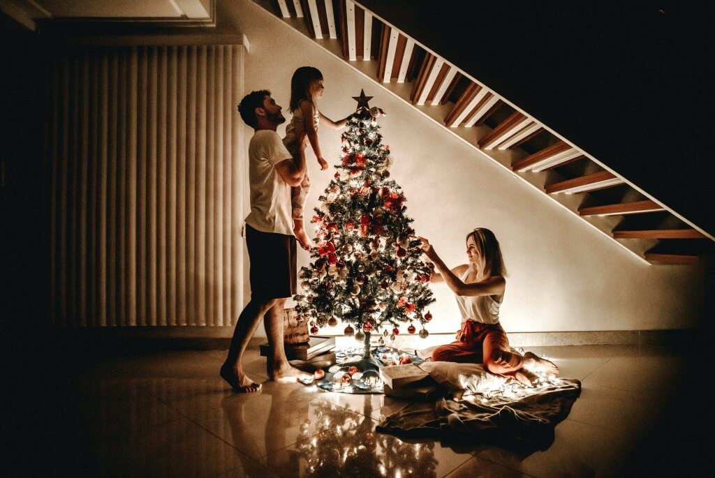 Family Decorating the Tree as a Affordable Holiday Activity
