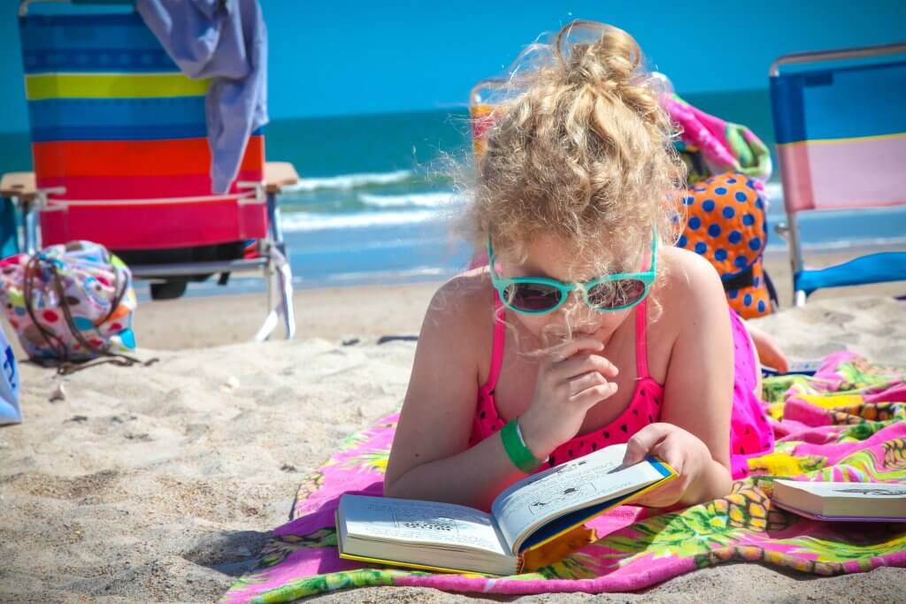 Kid on the Beach Reading to Prevent Summer Slide